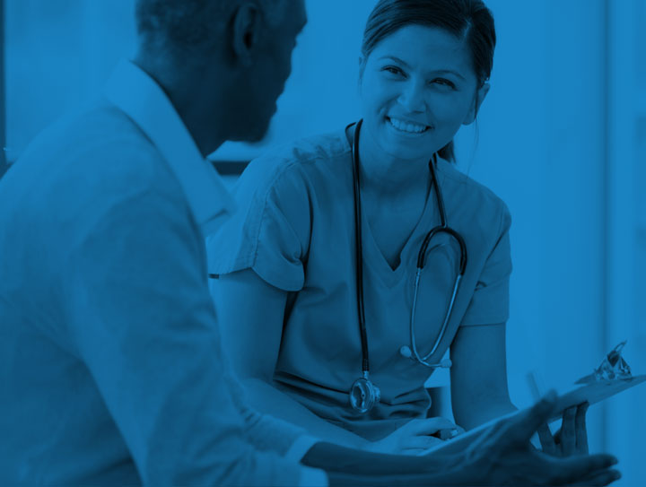 Our team is here to help Health care professional talking to patient about treatment options